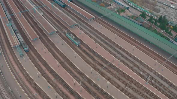 the Locomotive Runs on Rails Near the Central Platforms of the Railway Station alt