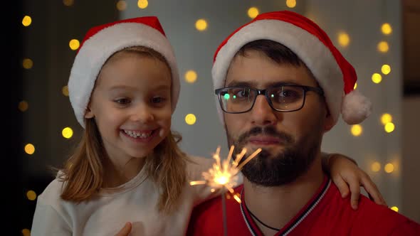 Father and Little Girl Set Fire Bengal Light and Smile alt