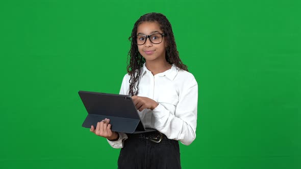 Genius African American Teen Girl Using Tablet Showing I Got an Idea Gesture on Green Screen alt
