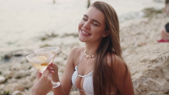 Pretty Hot Girl with Cocktail Sitting at Beach and Sunbathing at Holiday Resort