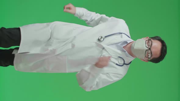 Asian Doctor With Stethoscope Wearing Mask, Running On Green Screen Chroma Key alt
