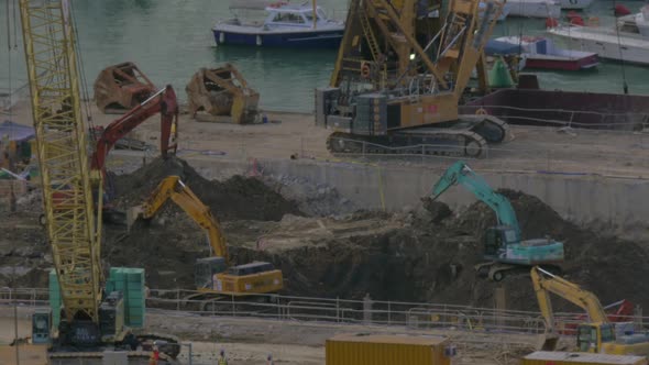 View of Excavators Digging a Hole Near Dock. Hong Kong, China alt