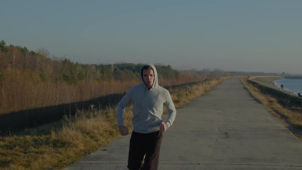 Young Man Is Jogging Outdoor
