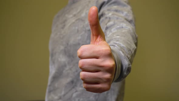 Man Showing Approval Gesture Thumbs Up in Camera