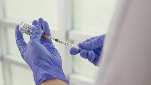 Closeup A Vial of the COVID19 Coronavirus Vaccine is Being Used By a Scientist alt