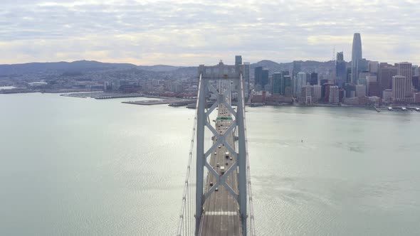 Aerial: drivers crossing the bridge towards the city, drone view alt