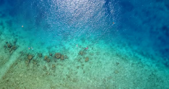 Wide angle flying copy space shot of a white paradise beach and aqua turquoise water background in 4 alt