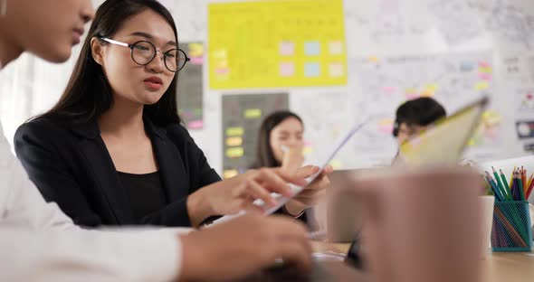 Female glasses coworker showing document with project alt