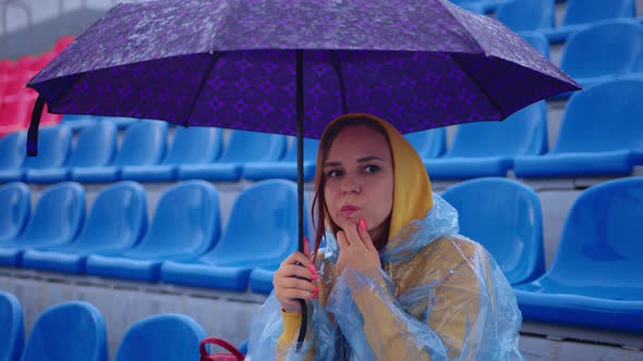 Pensive Lady with Umbrella Touching Chin and Looking Away on Tribune alt