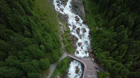 Drone aerial view from the giant Grawa water falls with the wooden viewing platform with some people alt