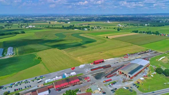 Aerial Traveling View of Corn Fields and Harvesting Crops, with Patches of Color alt