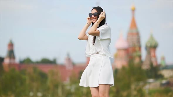 Happy Young Urban Woman Enjoy Music Outdoors