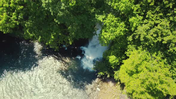 Birdseye View of Green Forest and Small Cute Waterfall in Its Depth Aerial alt