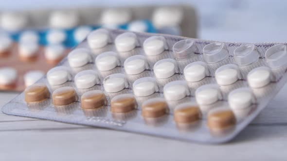 Birth Control Pills on Wooden Background, Close Up  alt