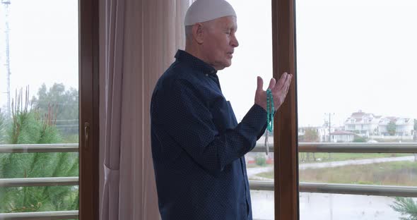 An Old Man with Rosary Beads Praying