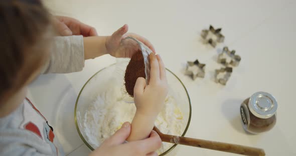 Young Mother and Daughter Having Fun Baking Cookies in the Kitchen Together alt