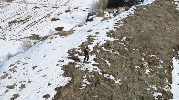 Young Student Walking Snow Aerial View alt