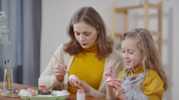 Woman and Girl Painting on Easter Eggs alt
