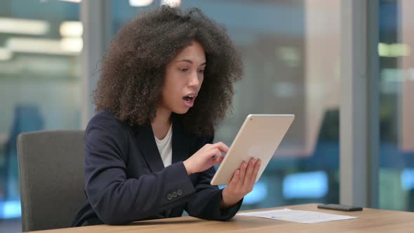 African Businesswoman Reacting to Loss on Tablet alt