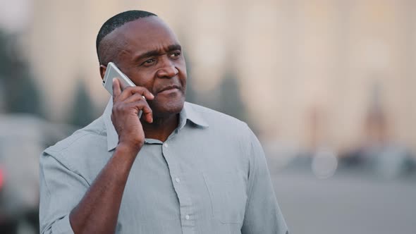 Serious Worried Nervous Mature Adult African American Man Standing Outdoors on Road Background alt