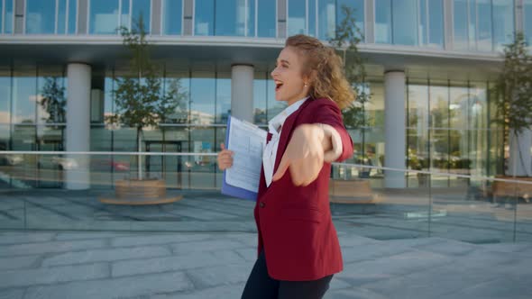 Successful Young Female Employee Dancing Outdoors Celebrating Promotion alt