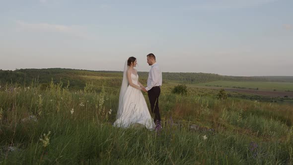 Married Couple Stands Smile and Hug Each Other alt