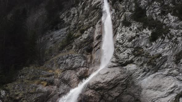Drone view of a waterfall in the Swiss Alps alt