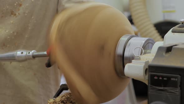 Carpenter Using Chisel for Shaping Piece of Wood on Lathe Close Up Slow Motion