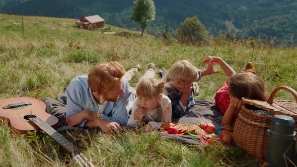 Parents Enjoy Picnic Children Lying Grass Mountain Slope alt