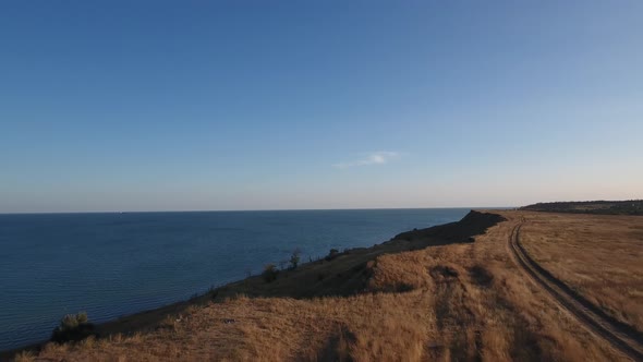 Sea and High Shore at Sunset alt