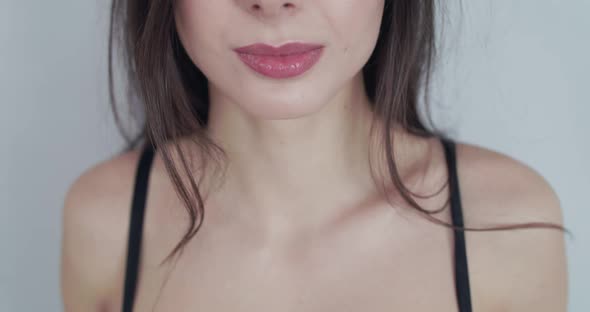 Unrecognizable Female Body Part She Puts on Headphones and Smiles on Background alt