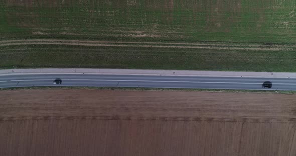 Aerial Drone Content  Road with Light Traffic on Outside City and Arable Lands