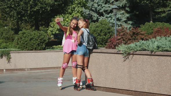 Two Teenage Girls on Roller Skates Make Selfie alt