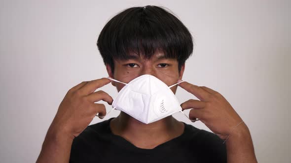 Asian man wearing medical mask alt
