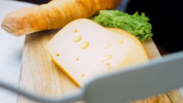Cheese with Holes on a Retrostyle Cooking Tray alt