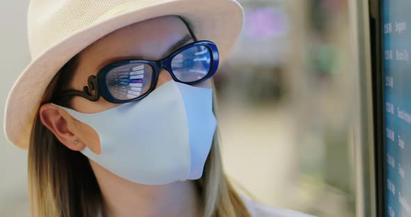 Close Up of Woman in COVID-19 Face Mask at Empty Airport. Safe Travels,  USA alt