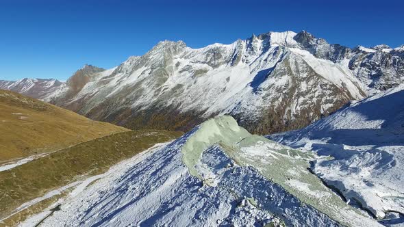 Aerial shot over glacier moraine in the Swiss Alps (Arolla, Valais - Switzerland)Autumn colors alt