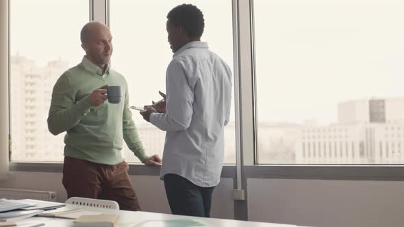 Discussing Work On Coffee Break alt