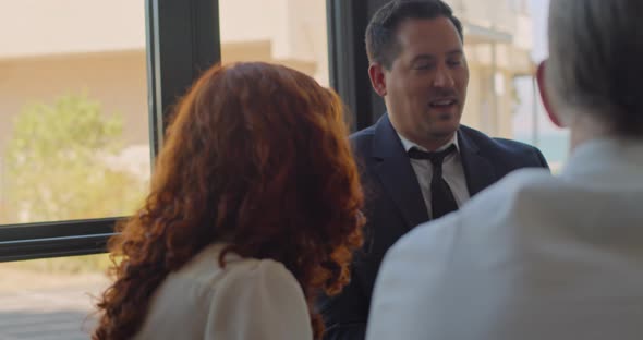 Group of business team colleges meeting for lunch in a coffeehouse during a break from work. alt