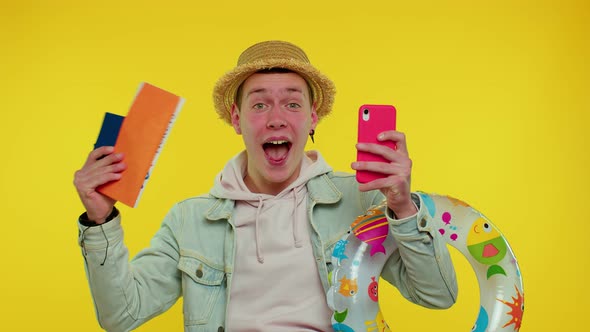 Teenager Man Tourist with Mobile Phone Celebrating Winning Holiday Resort Vacation Tickets Pass alt