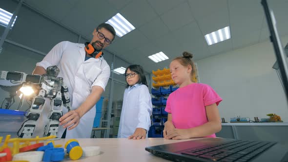 Demonstration Process of a Toy Robot To the Children Carried Out By a Male Professional alt