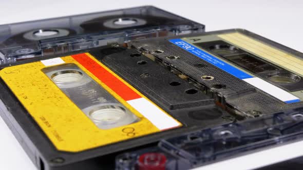 Four Audio Cassettes Rotate on White Background alt