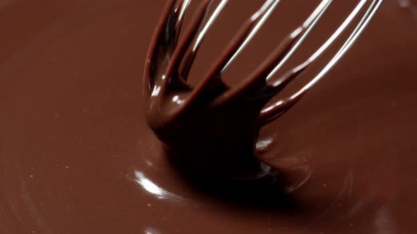 Mixing Stirring Melted Liquid Dark Chocolate with Whisk Confectioner Prepares Dessert Topping alt