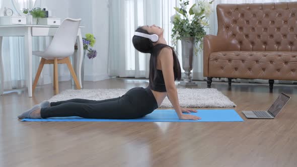 Exercise concept. Beautiful girl practice cobra asana at home. 4k Resolution.