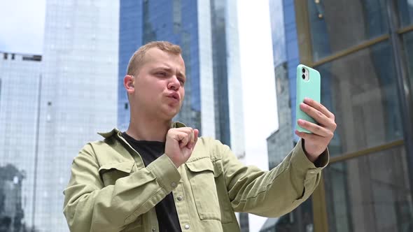 Caucasian Man Talking Sign Language Over Video Communication on Smartphone Outdoors alt