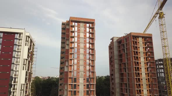 Aerial view of tall residential apartment buildings under construction. Real estate development. alt