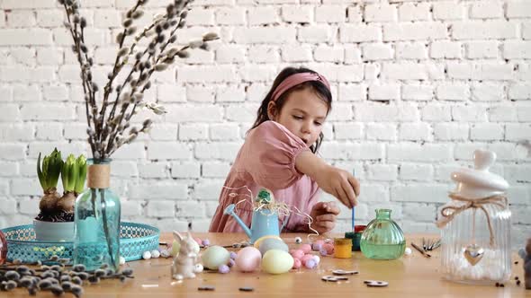 Little Girl and Mom Paints Eggs for Easter