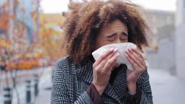 Young Beautiful Girl Teenager Millennial African American Woman with Curly Hair Stands in City on alt
