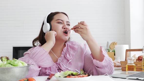 Asian overweight woman eating fresh salad. Weight loss and health concept.food