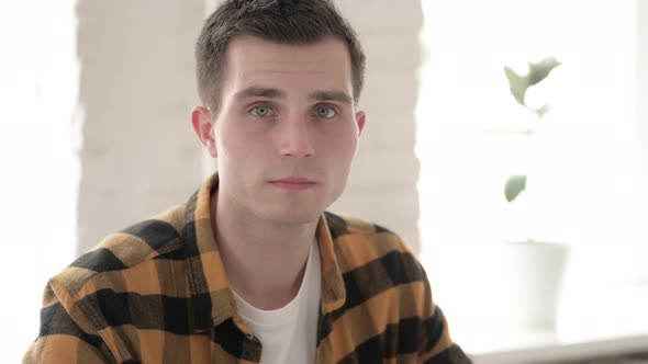 Casual Young Man Accepting Offer While Shaking Head alt